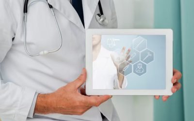 close-up-tablet-held-by-doctor_23-2148316916